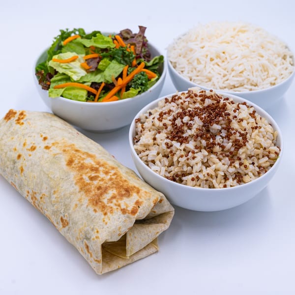 WOW TIKKA Indian burrito with a side salad, white rice, and quinoa on a white background.